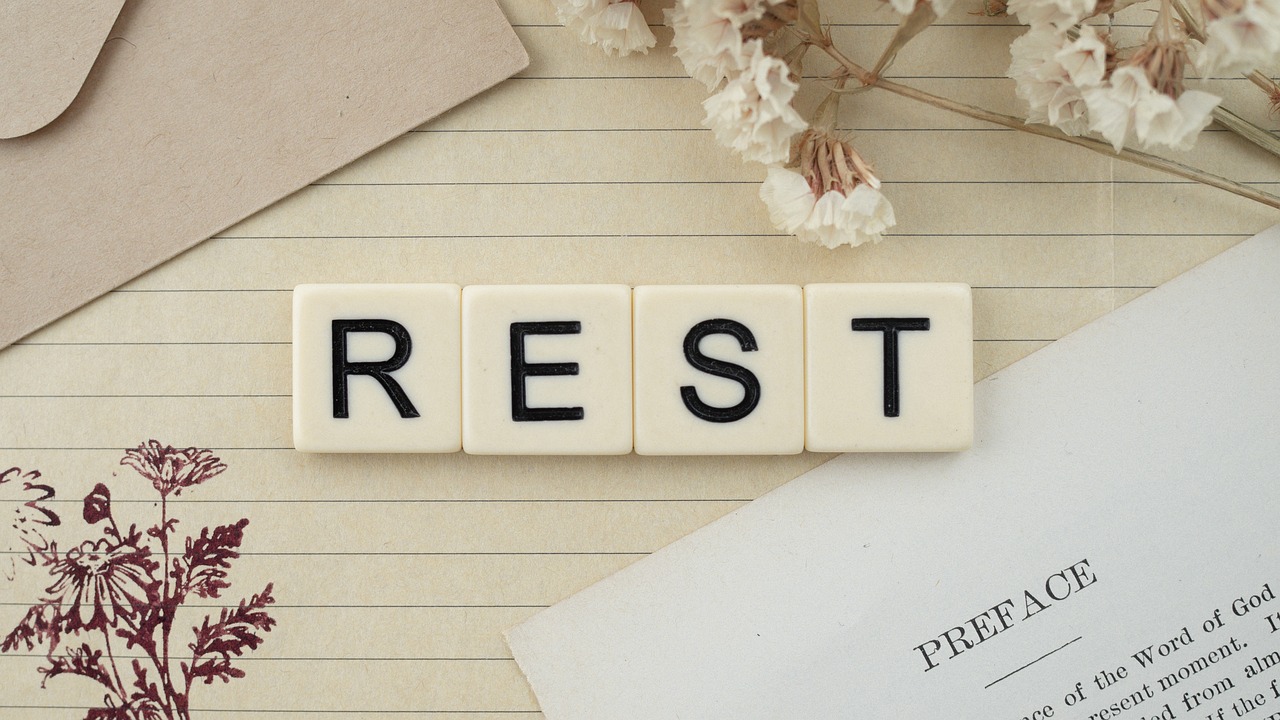 The word "REST" spelled out in square letter tiles.